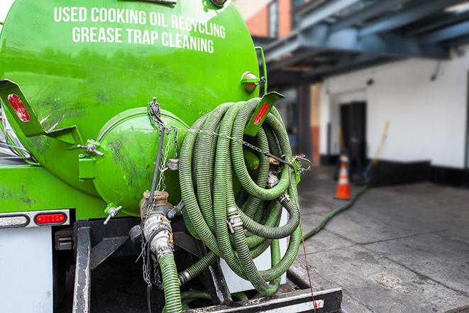 grease trap pumping truck in action in East Dundee